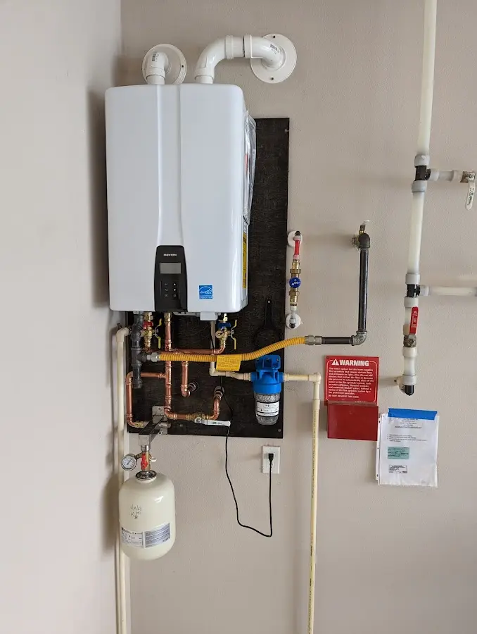 Professional plumber installing copper piping in a Boyertown home